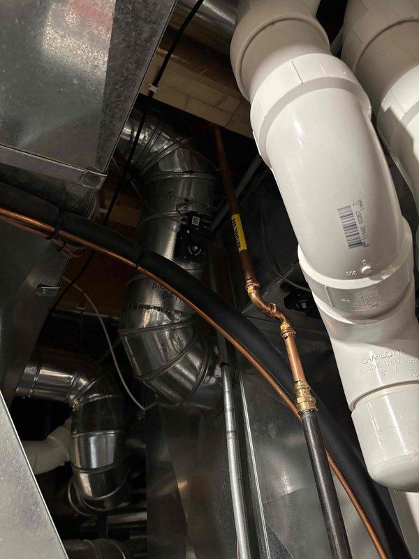 Responded to customer concern regarding an AprilAire 700 series humidifier leaking and low humidity levels. Upon inspection of the mechanical room, examined the PVC drainage system, copper supply line, and ductwork connections to the humidifier. Performed routine maintenance on the unit, clearing blockages in the drainage system that were causing water to back up. System now operating normally with proper humidity output and no leaks observed.