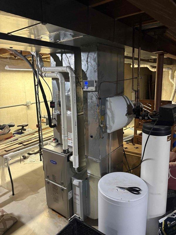 Responded to service call regarding gas odor in basement mechanical room. Upon inspection of Carrier furnace system, no gas leaks were detected. Visual examination of complete HVAC setup including ductwork, venting components, and adjacent water treatment equipment revealed normal operation. Customer was advised that the unusual smell was not gas-related and system is functioning safely.