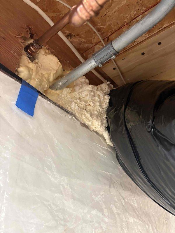 Responded to callback regarding insufficient insulation on make-up air intake connected to furnace return. Inspected metal vent pipe that was exhibiting condensation and allowing cold air infiltration. Applied spray foam insulation around the ductwork junction and sealed gaps between the metal vent pipe and surrounding structure to prevent thermal transfer and condensation issues.