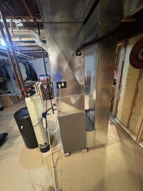 Completed installation of a Lennox EL297V 70K BTU high-efficiency furnace in basement utility area, including replacement of 20 feet of 2-inch cellular core PVC, installation of new media cabinet, and modification of return drop. Verified proper operation of existing gas valve, drain system, and electrical connections to Square D QO Panel (15 amp furnace circuit, 20 amp AC circuit). System properly sized for 1650 square foot residence.