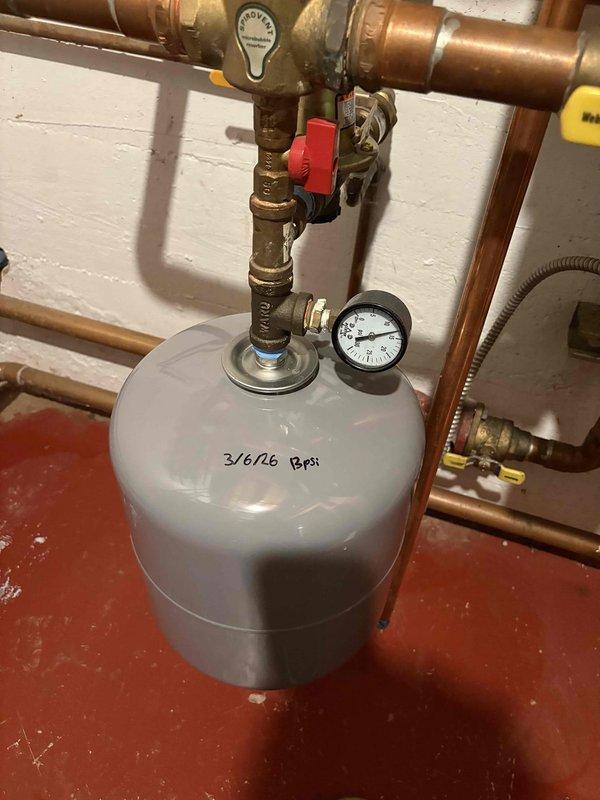 Responded to no-heat complaint in bedroom zone that was actually overheating despite thermostat being off. Diagnosed failed zone valve (Zone 4) causing continual heat flow to affected area. Replaced defective zone valve and also replaced aging expansion tank which was showing pressure issues (3/6/26 PSI markings indicated previous service). System now functioning properly with all zones responding correctly to thermostat commands.