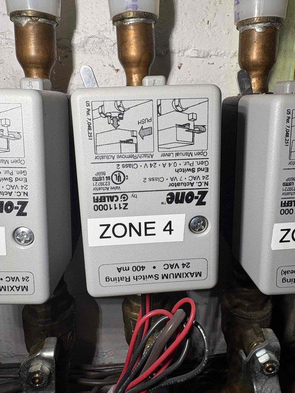 Responded to no-heat complaint in bedroom zone that was actually overheating despite thermostat being off. Diagnosed failed zone valve (Zone 4) causing continual heat flow to affected area. Replaced defective zone valve and also replaced aging expansion tank which was showing pressure issues (3/6/26 PSI markings indicated previous service). System now functioning properly with all zones responding correctly to thermostat commands.