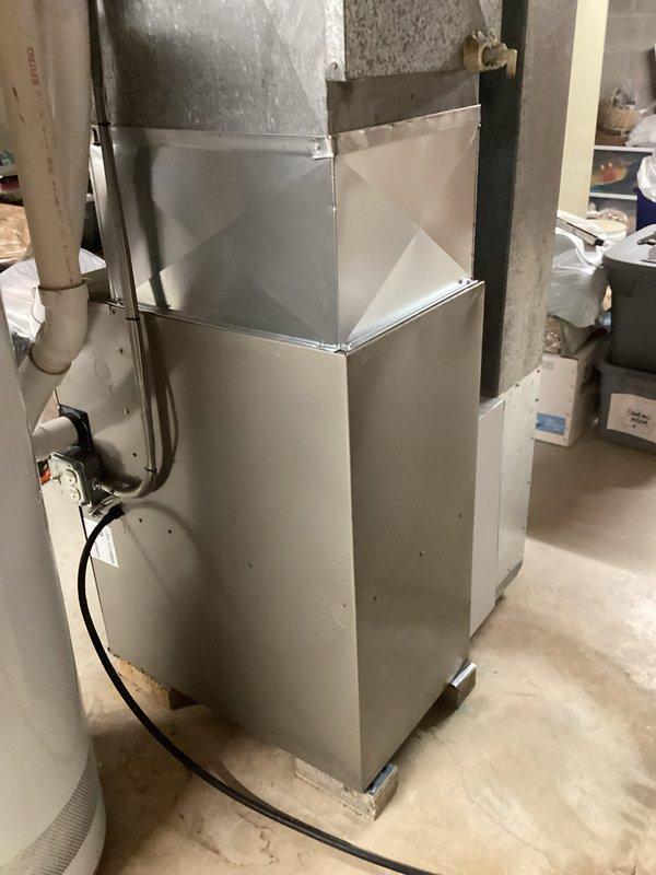 Removed existing four-piece duct board and replaced with custom fabricated four-piece sheet metal ductwork for Carrier furnace system. Installation completed successfully with proper connections to existing HVAC unit. New sheet metal ductwork provides improved airflow efficiency and durability compared to previous configuration.