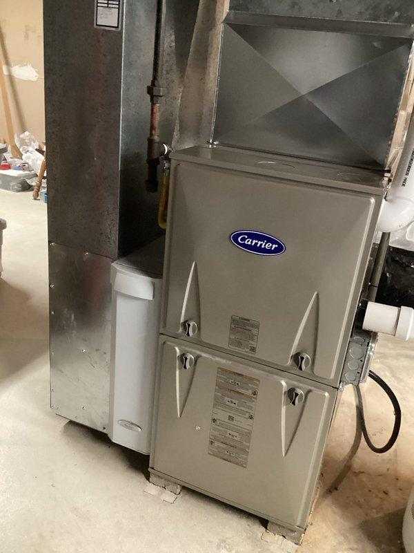 Removed existing four-piece duct board and replaced with custom fabricated four-piece sheet metal ductwork for Carrier furnace system. Installation completed successfully with proper connections to existing HVAC unit. New sheet metal ductwork provides improved airflow efficiency and durability compared to previous configuration.