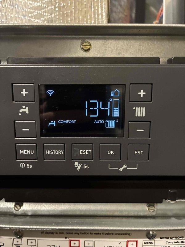 Responded to no heat complaint in master bedroom. Accessed and recalibrated the electronic control panel displaying incorrect temperature reading (134°). Utilized technical menu navigation to adjust system parameters according to manufacturer specifications, restoring proper heating function to the affected zone.