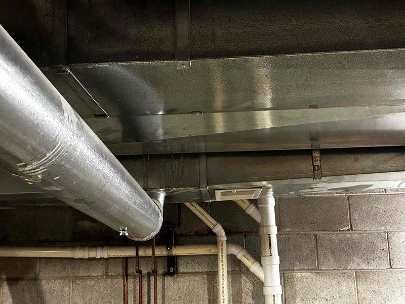 Responded to no-heat service call and discovered detached PVC vent pipe caused by collapsed ductwork from previous installation, which also damaged gas and water lines. Temporarily secured ductwork and reconnected vent pipe to restore safe operation; scheduled follow-up with additional personnel to properly rehang ductwork and repair damaged gas and water lines.