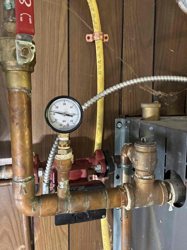 Responded to no heat call for aging boiler system. Inspected system components, finding normal pressure readings (15-20 psi) on gauge but observed significant copper pipe oxidation throughout. Serviced H2 PRO expansion tank which was properly mounted but required adjustment to restore proper heating function.