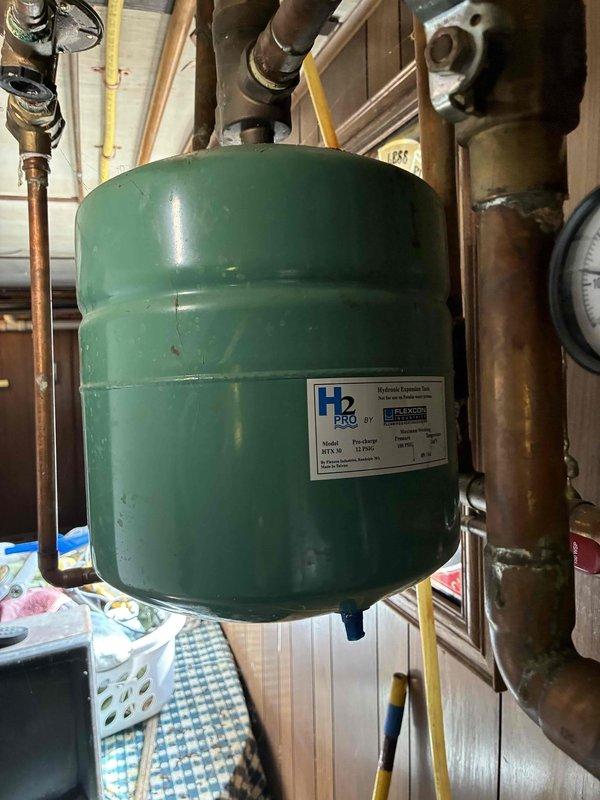 Responded to no heat call for aging boiler system. Inspected system components, finding normal pressure readings (15-20 psi) on gauge but observed significant copper pipe oxidation throughout. Serviced H2 PRO expansion tank which was properly mounted but required adjustment to restore proper heating function.