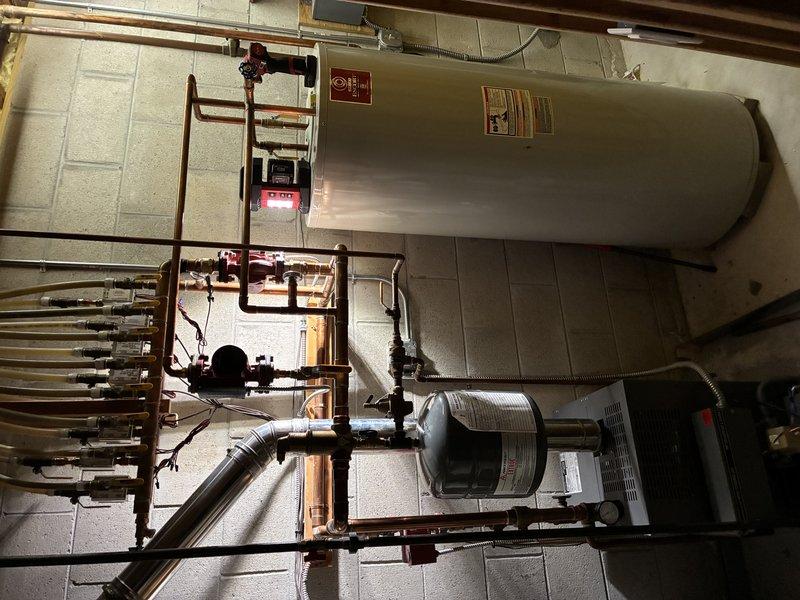 Responded to no heat and no hot water emergency call. Upon inspection, discovered draft motor had seized, preventing boiler operation. Successfully freed and lubricated the seized draft motor, restored boiler functionality, and confirmed hot water production resumed. Prepared comprehensive quote for customer consideration regarding full repair of draft motor assembly versus complete boiler replacement options.