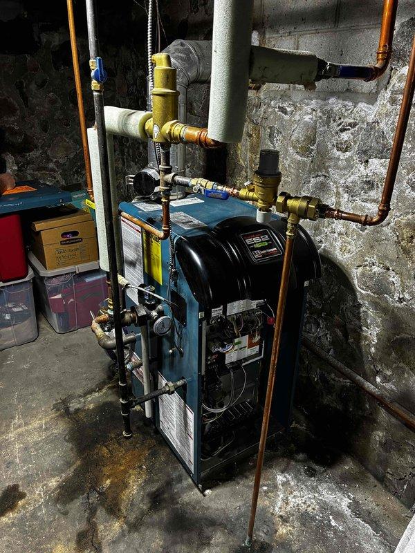 Responded to no heat condition and loud operation on older boiler system. Diagnosed failed autofill valve and failed pressure gauge as primary issues. Replaced backflow/autofill combination valve, pressure relief valve, and pressure gauge to restore proper system operation and safety controls. Performed complete boiler tuneup to optimize performance and efficiency.