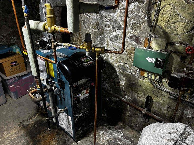 Responded to no heat condition and loud operation on older boiler system. Diagnosed failed autofill valve and failed pressure gauge as primary issues. Replaced backflow/autofill combination valve, pressure relief valve, and pressure gauge to restore proper system operation and safety controls. Performed complete boiler tuneup to optimize performance and efficiency.