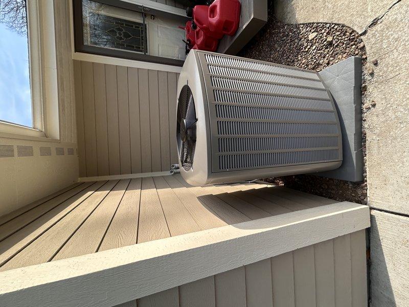 Completed full first-floor HVAC system installation including SLP99 70,000 BTU furnace, EL18KCV 3-ton air conditioner with 36B cased coil, AA 700 air purification system, S40 thermostat, and averaging room sensor for the addition. Installed 30-foot line set running through crawlspace, added second 2-inch PVC intake pipe (25-30 feet) through crawlspace, installed media cabinet, and replaced return drop. Updated electrical service with Square D Homeline panel including dedicated 15-amp circuit for furnace and 30-amp circuit for air conditioning unit. Outdoor condenser unit positioned on concrete pad with proper clearances, all wiring completed per manufacturer specifications, and system tested for proper operation.