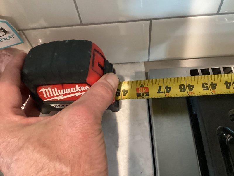 Responded to callback for gas stove regulator humming issue. Upon arrival, utility company had already verified proper meter pressure. Measured gas pressure at stove and confirmed 2 psi, which exceeded appliance specifications. Shut off gas supply, installed step-down regulator on gas line behind stove per utility company recommendation, and restored service. Tested all stove operations to verify proper function and confirmed issue resolved.