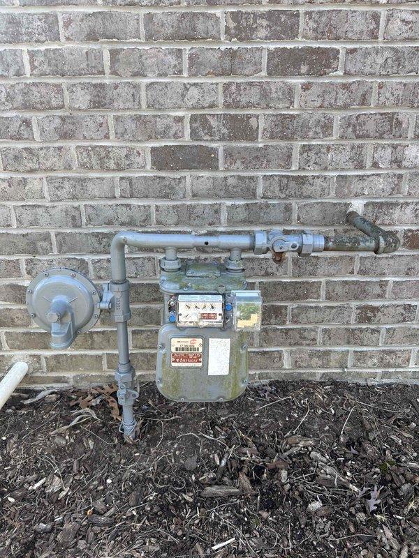 Installed a 26KW Kohler standby generator with two 200-amp RXT automatic transfer switches to provide backup power for the residence. Set concrete pad for generator placement, positioned unit against exterior brick wall with proper clearances, completed all electrical connections and gas line hookup to existing meter assembly, and restored decorative rock landscaping around installation area. Unit ready for final registration and commissioning test per promotional timeline.