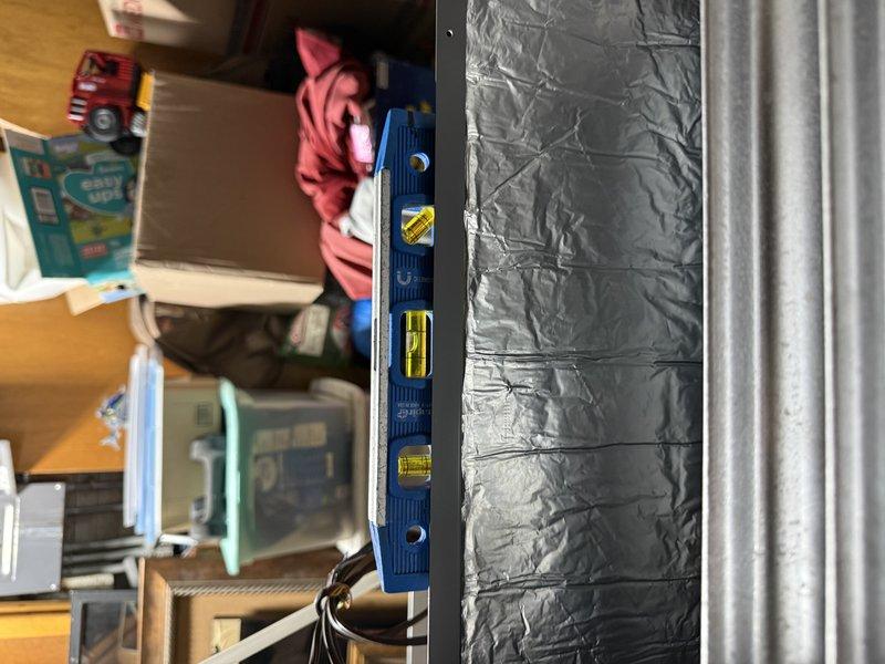 Completed installation of EL297E 90,000 BTU high-efficiency furnace in residential garage/utility area. Unit was properly positioned, leveled, and secured with all necessary venting, gas connections, and electrical hookups completed per manufacturer specifications and local code requirements.