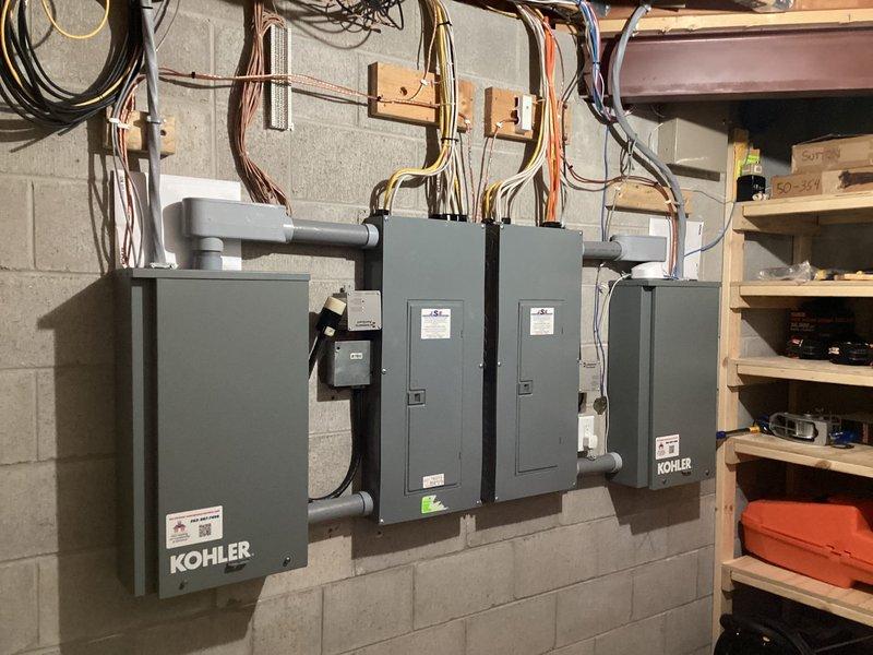 Completed installation of Kohler 26RCA standby generator system with dual RXT transfer switches to provide automatic backup power solution. Performed all final electrical connections, conduit runs, and panel terminations in basement utility area, with proper wire management and code-compliant mounting on masonry wall. System tested and operational, providing seamless power transfer capability for essential circuits.