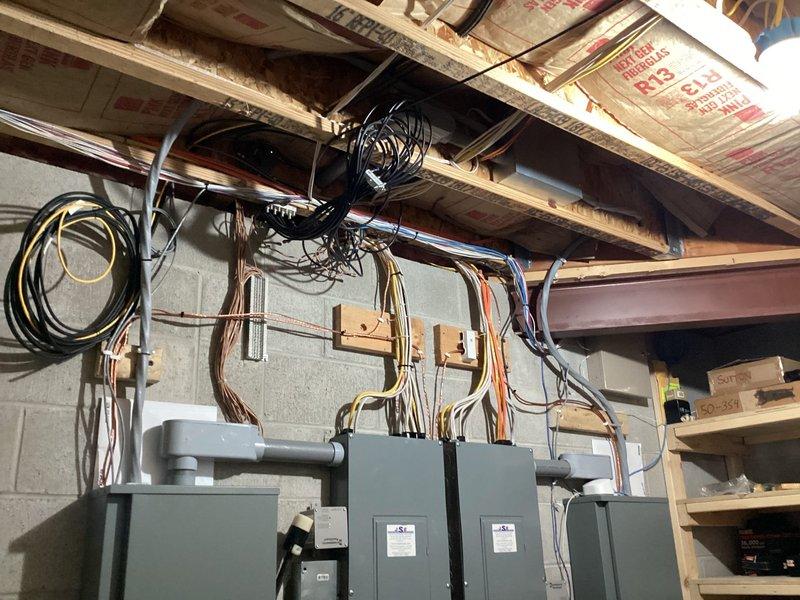 Completed installation of Kohler 26RCA standby generator system with dual RXT transfer switches to provide automatic backup power solution. Performed all final electrical connections, conduit runs, and panel terminations in basement utility area, with proper wire management and code-compliant mounting on masonry wall. System tested and operational, providing seamless power transfer capability for essential circuits.