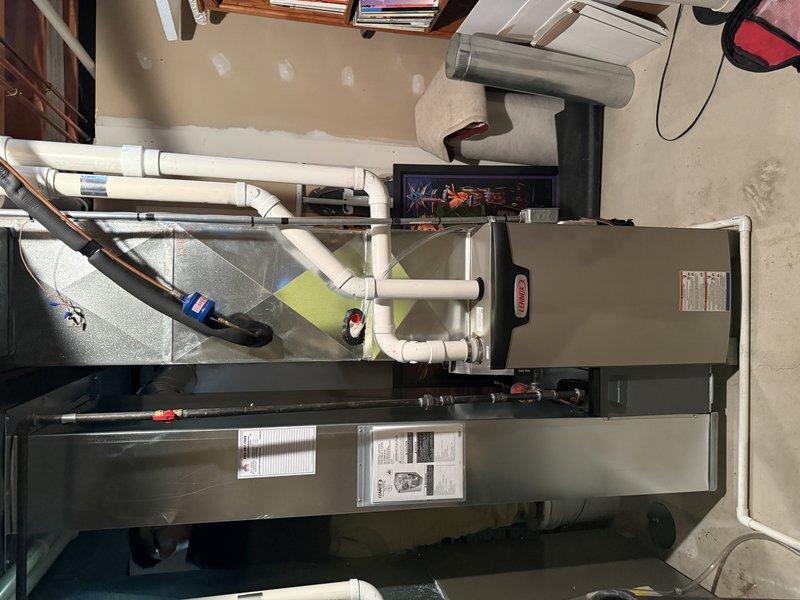 Completed full HVAC system installation for 1,570 square foot first floor application. Installed SLP99 70K BTU furnace with S40 thermostat as primary heating system. Removed first 4 feet of existing 2-inch cellular core ductwork off furnace discharge and replaced with proper 2.5-inch solid core material to match remaining 10 feet of trunk line. Replaced existing 8x22 return air drop and relocated closer to furnace for improved efficiency. Installed new media cabinet for filtration system. Completed all PVC condensate drain connections utilizing existing drain location near furnace. Verified existing air conditioning system compatibility and integration with new furnace. Installed 15-amp dedicated electrical circuit utilizing existing Square D QO panel with conduit run to ceiling and Romex connection to furnace, eliminating need for licensed electrician. Patched wall opening from return relocation. Tested all system operations including heating cycle, thermostat functionality, airflow d