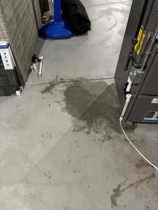 Responded to service call for Lennox furnace with water leakage issues evident on concrete floor surrounding unit. Upon inspection, identified broken condensate drain trap causing moisture accumulation and potential water damage. Removed damaged PVC drain trap assembly and cleared debris from drain line to ensure proper flow. Installed new drain trap with correct slope configuration to prevent future drainage problems and backflow issues. Verified all connections were properly sealed to eliminate potential leaks. Conducted full system run test to confirm condensate drainage functioning correctly with no leaks present. System returned to normal operation with proper condensate removal.