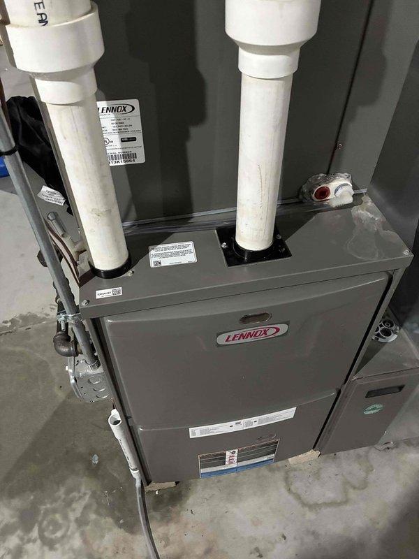 Responded to service call for Lennox furnace with water leakage issues evident on concrete floor surrounding unit. Upon inspection, identified broken condensate drain trap causing moisture accumulation and potential water damage. Removed damaged PVC drain trap assembly and cleared debris from drain line to ensure proper flow. Installed new drain trap with correct slope configuration to prevent future drainage problems and backflow issues. Verified all connections were properly sealed to eliminate potential leaks. Conducted full system run test to confirm condensate drainage functioning correctly with no leaks present. System returned to normal operation with proper condensate removal.