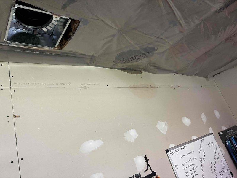 Responded to emergency call for water leaking from ceiling. Upon inspection, identified compromised PVC condensate drain line causing active water intrusion. Assessed installation to determine if issue stemmed from recent installation work versus existing equipment failure. Documented findings with photographs showing ceiling damage, drywall water staining, and affected areas for further evaluation and proper billing determination.