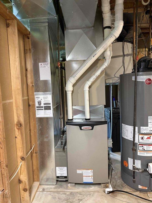 Completed installation of Lennox EL297V 90,000 BTU high-efficiency furnace for 2,130 square foot residence. Replaced 30 feet of 3-inch cellular core PVC venting with proper pitch and termination. Reused existing media cabinet and return air drop, supplied new 16x25x4 filter for system startup. Verified existing gas valve and condensate drain for proper operation and compatibility with new equipment. Installed new cased evaporator coil in "C" cabinet configuration for upcoming air conditioning system. Updated electrical service at Cutler Hammer panel with dedicated 20-amp circuit for furnace and 20-amp circuit for AC unit per manufacturer specifications and local code requirements. Tested all safety controls, verified proper combustion, and confirmed system operation. Unit leveled, secured, and commissioned successfully.