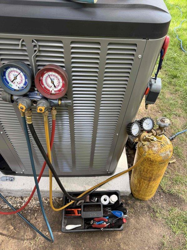 Completed full HVAC system installation for 1,250 square foot residence. Installed SLP99 70,000 BTU high-efficiency furnace with new 2" PVC venting, approximately 80-90% efficient with 25-foot run lengths. Maintained proper code clearance distance from new power vent water heater. Installed EL22KCV 2-ton evaporator coil with 30B coil configuration. Added new media cabinet and replaced return drop. Removed all existing metal B-vent and cut old vent to ceiling level. Installed S40 programmable thermostat with room sensor for enhanced temperature control. Connected 15-amp electrical circuit to Square D Homeline panel for furnace operation. Verified existing gas valve and condensate drain were acceptable for continued use. Completed outdoor AC condenser installation on concrete pad, charged refrigerant system to manufacturer specifications, and performed full system startup and testing to ensure proper operation of complete heating and cooling system.