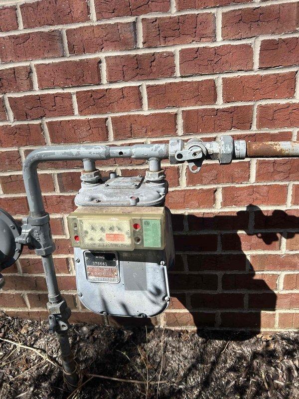 Installed a Kohler 26RCA 26KW standby generator system with natural gas connection at residential property over two installation days following initial pad placement. Installation included one Kohler RXT 200-amp automatic transfer switch and two Kohler load shed modules to manage electrical loads during generator operation. Connected generator to existing natural gas meter, verified all electrical connections to main service panel, programmed transfer switch for automatic operation during utility power loss, and tested system for proper functionality.