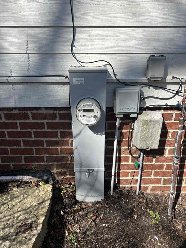 Installed a Kohler 26RCA 26KW standby generator system with natural gas connection at residential property over two installation days following initial pad placement. Installation included one Kohler RXT 200-amp automatic transfer switch and two Kohler load shed modules to manage electrical loads during generator operation. Connected generator to existing natural gas meter, verified all electrical connections to main service panel, programmed transfer switch for automatic operation during utility power loss, and tested system for proper functionality.