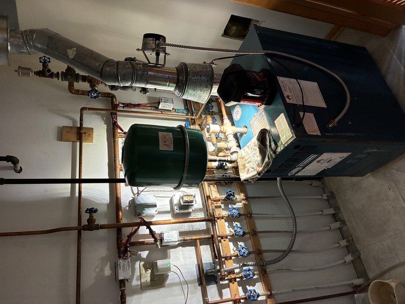 Completed prepaid monthly maintenance on two air conditioning units, including standard tune-ups and replacement of 16x25x4 air filters. Both AC systems tested within normal operating parameters with no issues found. Investigated reported intermittent screeching noise from boiler system and identified a faulty zone valve as the likely source of the noise. During inspection of the hydronic heating system, discovered a leaking expansion tank requiring replacement. Documented equipment conditions with photographs of the boiler room mechanical systems and performed diagnostic testing with manifold gauges and digital thermometer. Ordered replacement zone valve and expansion tank; follow-up appointment to be scheduled upon parts arrival to complete boiler repairs.
