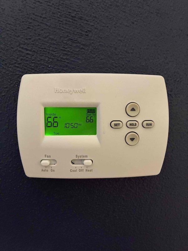 Responded to service call for malfunctioning thermostat with erratic programming behavior. Evaluated existing Honeywell digital thermostat and determined unit was experiencing control issues. Replaced faulty thermostat with new T6 model to restore proper system operation and programming functionality.