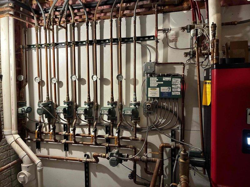 Responded to no heat and no hot water emergency call on hydronic boiler system. Upon inspection, discovered melted pressure switch tubing and identified exhaust venting into boiler cabinet through an open bolt hole. Replaced damaged pressure switch tubing and plugged the missing bolt hole to restore proper exhaust venting and safe operation. System tested and returned to normal operation with heat and hot water restored.