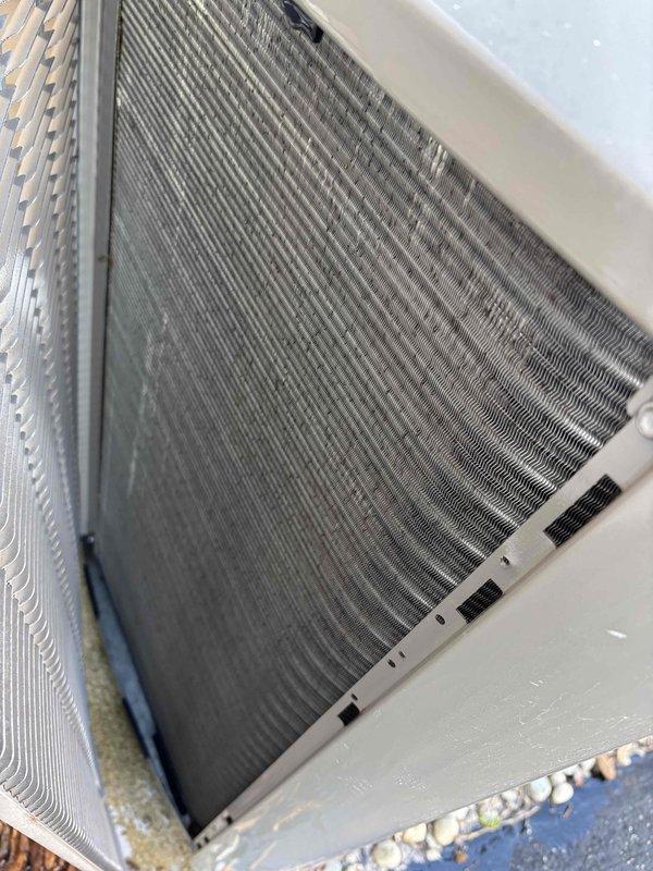 Completed scheduled maintenance agreement service on residential air conditioning system. Performed comprehensive inspection of outdoor condenser unit, which showed normal operational wear with moderate debris accumulation on coil fins. Unit is functioning properly with no mechanical issues identified. Condenser is properly positioned on concrete pad with adequate clearance and drainage. All components inspected and found to be in good working order.