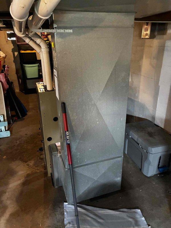 Responded to service call for water pooling near filter area and under furnace. Diagnosed system as low on R22 refrigerant, causing evaporator coil to freeze and resulting in condensate overflow. Documented existing air handler and outdoor condensing unit conditions, and provided customer with system replacement options due to age of equipment and R22 refrigerant phase-out.
