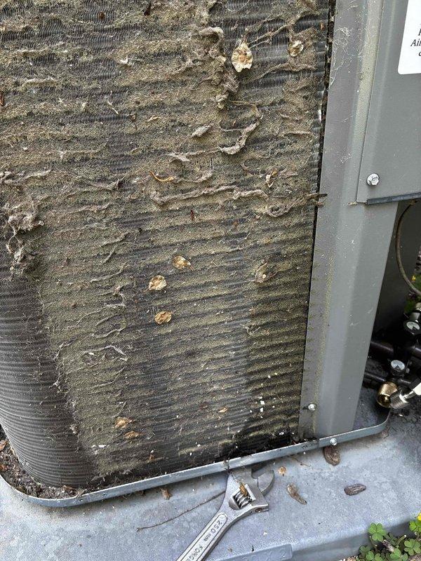 Performed comprehensive leak test on non-operational air conditioning system and identified leak in exterior evaporator coil. The coil exhibited significant dirt and debris accumulation between fins, with heavy grime buildup affecting overall system performance. Documented equipment condition with photographs showing the failed coil assembly and surrounding mechanical components in crawlspace area. Provided customer with detailed estimate for complete coil replacement to restore cooling functionality.