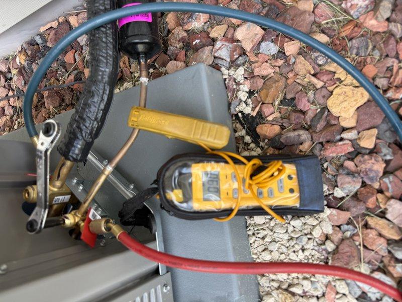 Responded to callback on recent HVAC installation where outdoor unit failed to start and produced clicking noise. Diagnosed system as overcharged with refrigerant, preventing proper compressor operation. Recovered 1.00 lbs of refrigerant using manifold gauge set to bring system to proper charge levels, verified pressures, and restored normal cooling operation.