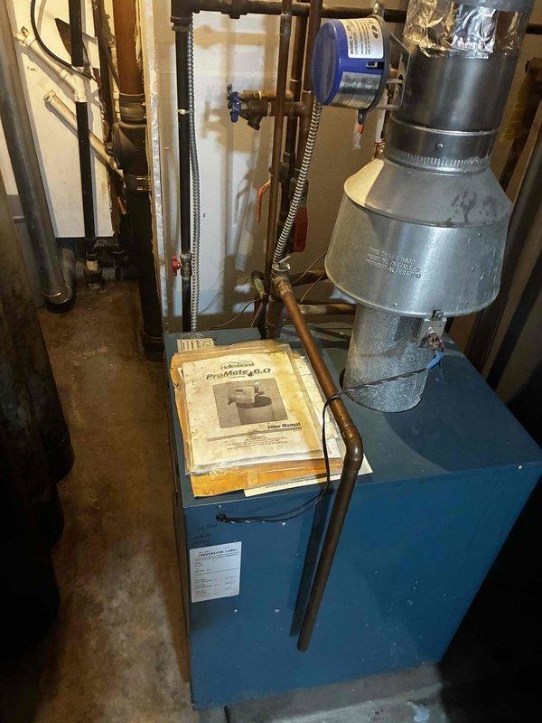 Responded to no cooling complaint on aging HVAC system. Found unit low on refrigerant and condensate drain line completely plugged, preventing proper operation. Recharged system to manufacturer specifications, verified proper airflow across evaporator coil, and cleared drain line obstruction by blowing through tubing to restore drainage. System restored to normal cooling operation with all components functioning properly.