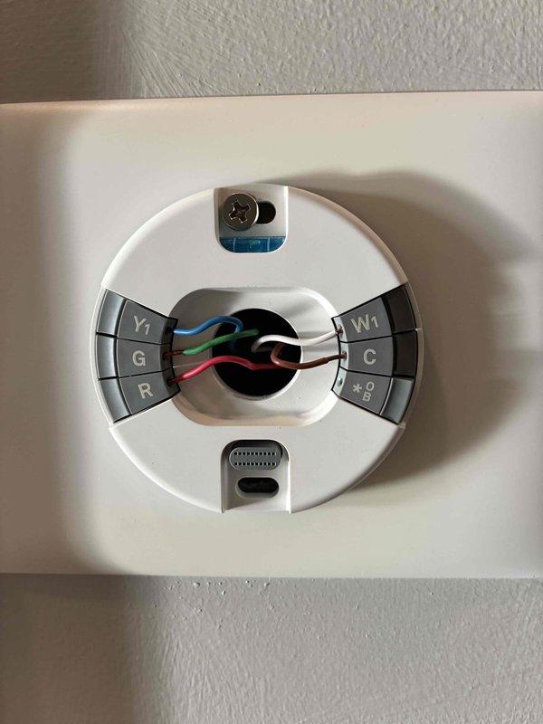 Responded to after-hours emergency call for no power to rooftop AC unit with water present on ground. Upon arrival, inspected thermostat wiring and confirmed proper connections at R, C, Y1, G, and W1 terminals. Traced power issue to rooftop unit and identified water intrusion as source of electrical failure. Assessed indoor air handler and surrounding mechanical equipment for water damage. Restored power to system after addressing water intrusion issue and verifying all electrical connections were secure and dry.