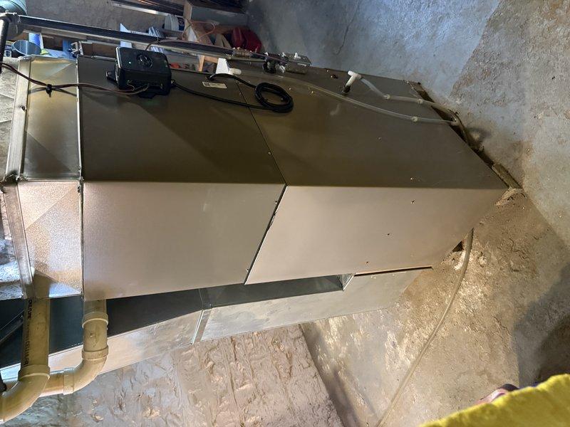Completed installation of ML13KC1 2-ton air conditioning system with 24B-71 cased coil for 1,300 square foot residence with 8 supply registers. Replaced 30-foot refrigerant line set with "B" width configuration and installed 20-amp breaker in Bryant Square D QO electrical panel. Air handler unit mounted in utility space with proper drainage confirmed and all electrical connections completed to manufacturer specifications.