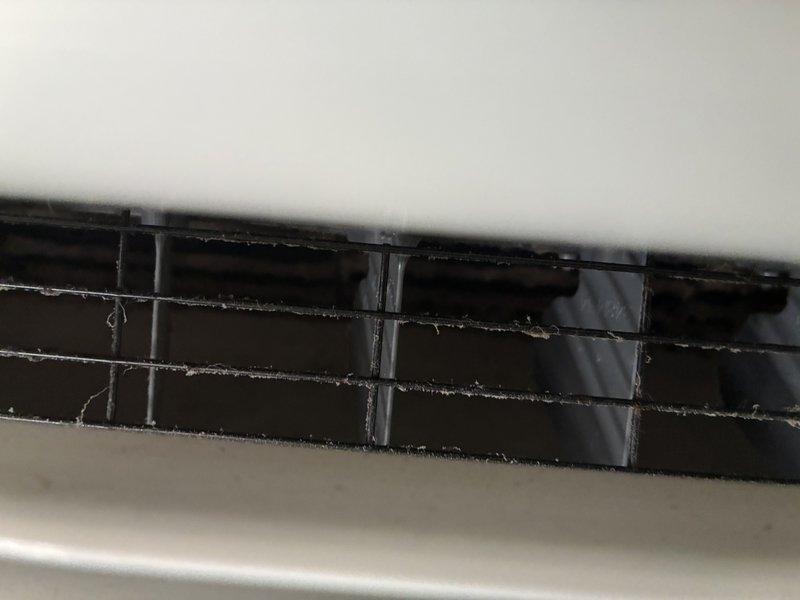 Responded to complaint of mini split system blowing black debris into occupied space. Previous service call addressed cooling issue and unit was operational. Upon inspection, found evaporator coil heavily contaminated with dust, dirt, and mold accumulation causing particulate discharge through supply vents. Removed and cleaned blower wheel assembly and evaporator coil. Cleaned interior louvers and air distribution components. Verified proper airflow and operation. Unit now operating normally with no debris discharge. Advised tenant on filter maintenance schedule to prevent future buildup.