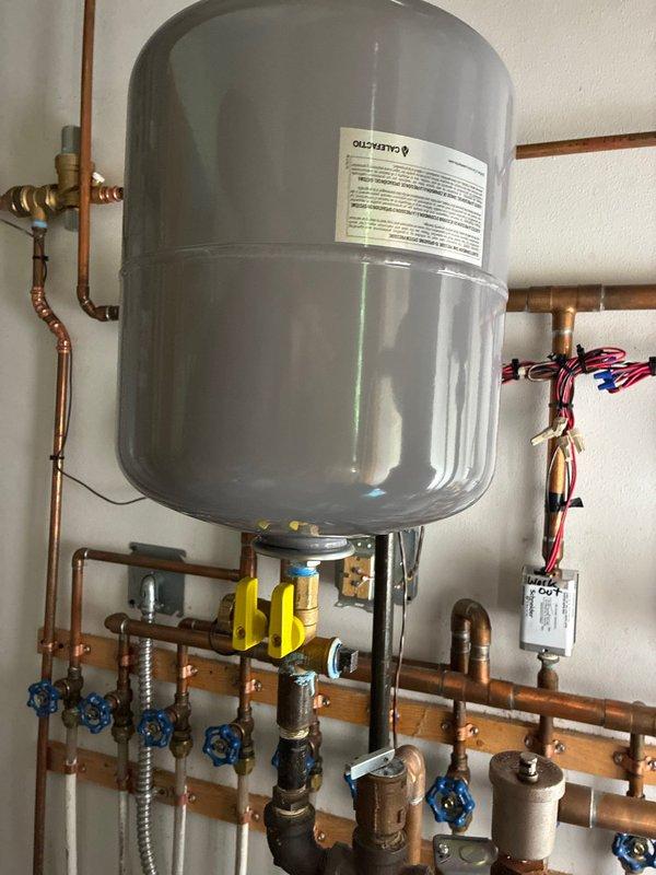 Responded to service call for reduced cooling capacity on main level air conditioning system and boiler component failures. Diagnosed AC issue as operator error and restored proper system operation. Replaced failed boiler expansion tank due to leaking condition and installed new shut-off valve. Zone valve identified for warranty replacement with parts supplied by Design Air. Performed system diagnostics using pressure and temperature measurements to verify proper operation of both cooling and heating systems following repairs.