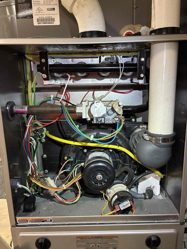 Performed preventive maintenance inspection on residential air conditioning system and furnace unit under maintenance agreement. Documented existing HVAC installation including exterior refrigerant line set with proper insulation, condensate drain line, and furnace interior components including heat exchanger, gas valve assembly, control board, and blower motor assembly, confirming all systems operational and customer enrolled in maintenance program.