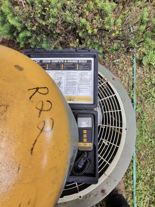 Completed full HVAC system installation including new air conditioning unit and evaporator coil. Removed existing WE Energies green utility box and obsolete outdoor condensing unit. Installed new AC pad for proper equipment placement and replaced electrical disconnect for code compliance. Ran new 25-foot refrigerant line set to connect outdoor condensing unit to indoor evaporator coil. Relocated humidifier to side of plenum to clear water heater gas line and allow proper installation of cased coil on top of B-width furnace. Charged system to manufacturer specifications using precision refrigerant scale and verified proper operation of all components. System tested and left in full working order.