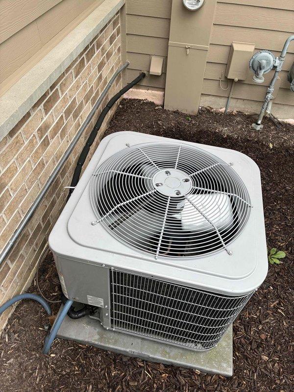 Responded to service call for zoned HVAC system evaluation at recently purchased residence. Homeowner reported temperature discrepancies in multiple zones, specifically master bedroom maintaining 77°F when thermostat set to 74°F. Inspected outdoor condensing unit, verified proper operation and airflow through top-mounted fan assembly. Examined zoning control panel and associated electrical components in interior panel box. System appeared to be functioning within normal parameters at time of inspection, consistent with homeowner's observation of improved performance since initial concerns.