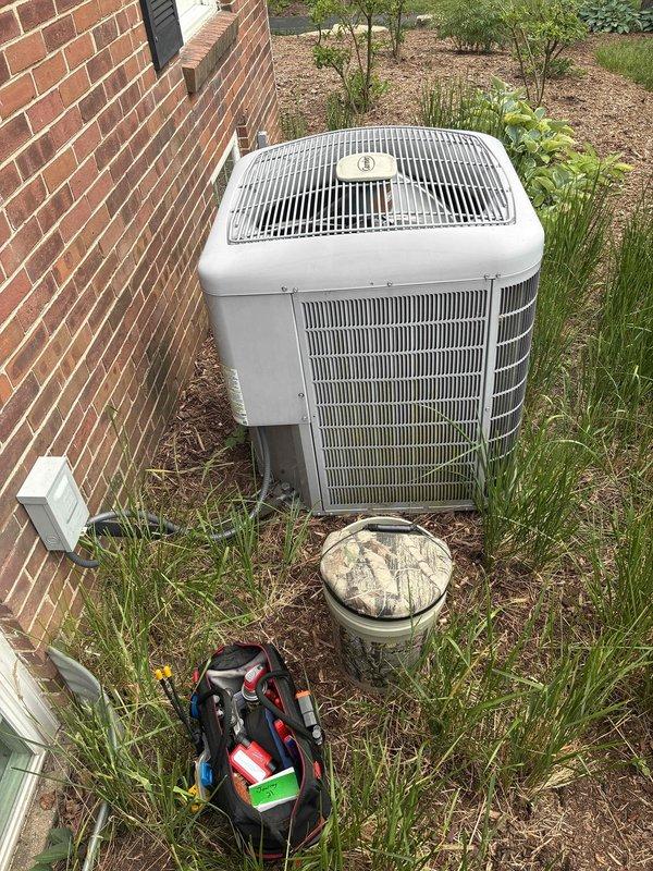 # HVAC Service Call - No Cooling Condition

Responded to a no cooling complaint on a residential air conditioning system over 10 years old. Upon arrival, located the outdoor condensing unit positioned on a concrete pad adjacent to the building structure. Performed visual inspection of the equipment exterior, noting the unit's age and general condition.

Conducted electrical diagnostics at the outdoor unit's terminal block and connection points. Inspected all wire terminations including the common, compressor, fan motor, and capacitor connections. Checked for proper voltage supply to the unit and verified integrity of electrical connections at the terminal board. Examined the condition of wiring insulation and terminal tightness, noting signs of age-related wear and outdoor environmental exposure on electrical components.

Assessed the condensing unit's physical condition, including the condenser coil fins, protective grille, and overall structural integrity. Verified unit placement and
