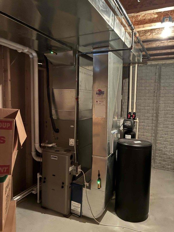 # HVAC Service Call - No Cooling Complaint

Responded to no cooling complaint on residential split system. Upon arrival, performed diagnostic evaluation of both indoor air handler unit located in basement mechanical room and outdoor condensing unit positioned on exterior of home. 

Conducted comprehensive system inspection including visual assessment of equipment condition, electrical connections, refrigerant lines, and overall installation integrity. Verified thermostat operation and system controls. Documented existing equipment configuration with indoor air handler connected to ductwork system and outdoor condenser unit properly positioned on mulch bed against home exterior with appropriate clearances.

Given the age of the system (10+ years old), performed thorough evaluation to identify root cause of cooling failure. Checked for common failure points including compressor operation, fan motor functionality, capacitor condition, refrigerant charge levels, and electrical component in