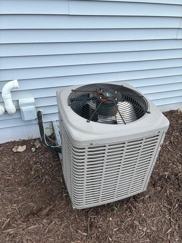 # HVAC Service Call - No Cooling Complaint

Responded to no cooling complaint on residential split system. Upon arrival, performed diagnostic evaluation of both indoor air handler unit located in basement mechanical room and outdoor condensing unit positioned on exterior of home. 

Conducted comprehensive system inspection including visual assessment of equipment condition, electrical connections, refrigerant lines, and overall installation integrity. Verified thermostat operation and system controls. Documented existing equipment configuration with indoor air handler connected to ductwork system and outdoor condenser unit properly positioned on mulch bed against home exterior with appropriate clearances.

Given the age of the system (10+ years old), performed thorough evaluation to identify root cause of cooling failure. Checked for common failure points including compressor operation, fan motor functionality, capacitor condition, refrigerant charge levels, and electrical component in
