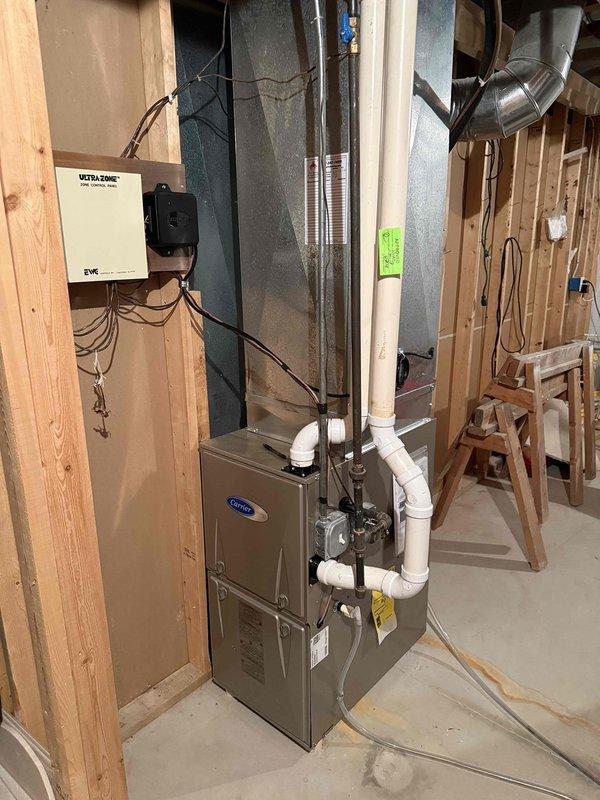 Completed installation of new Carrier air conditioning unit and evaporator coil system in residential property. Removed existing AC unit and installed replacement outdoor condenser with corresponding indoor coil, integrated with existing furnace and ductwork system. Verified all electrical connections to control board, confirmed proper wiring to zone control system, tested system operation, and ensured all refrigerant lines and condensate drainage were properly connected and functional.