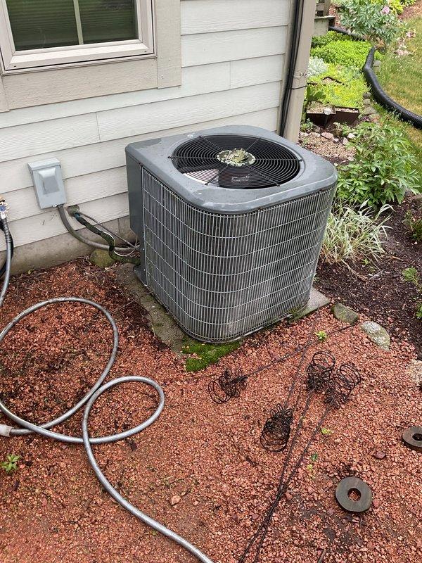 # HVAC Service Report

Responded to service call for inadequate cooling performance and extended cool-down times on Rheem model RCC42C2C air conditioning system (S/N 0412500356). Upon inspection, confirmed system was not producing adequate cooling. Diagnostic testing revealed low refrigerant charge with visible ice formation on refrigerant lines and evaporator components. Unit specifications indicate 110V/60Hz/1-phase outdoor section with factory charge. Exterior condensing unit showed signs of age with accumulated dirt and debris on coil fins and housing. Documented system condition with photographs of unit nameplate and exterior installation. Due to severity of refrigerant loss and freezing condition, recommended system evaluation for potential replacement. Forwarded customer information to sales team for complimentary replacement quote.