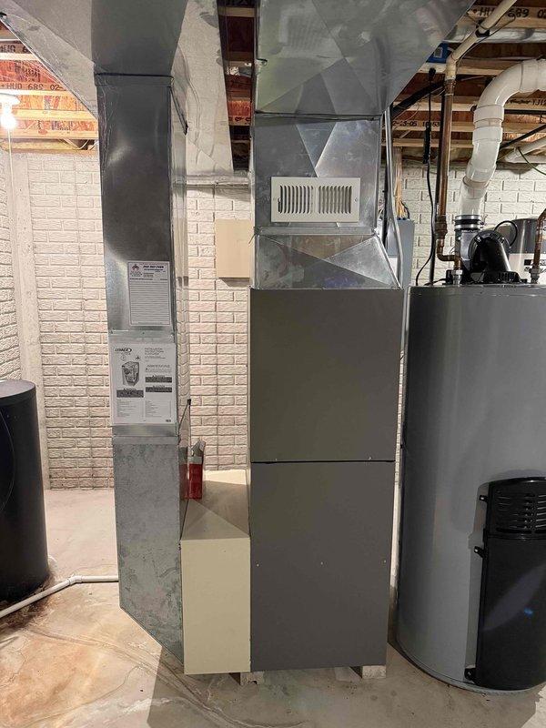 Completed full HVAC system replacement for 2200 square foot residence, including new furnace, air conditioning unit, and evaporator coil. Removed existing aged equipment and installed new units in basement mechanical room. Reused existing return air drop and media cabinet to maintain air filtration system. Retained 2" solid core PVC condensate drain line from previous installation. Replaced 25-foot refrigerant line set connecting outdoor condenser to indoor coil. Removed old equipment mounting brackets from exterior pad location, installed stone base and new equipment pad for proper condenser support and drainage. Installed dedicated electrical circuits with Square D QO breakers: 15-amp circuit for furnace and 30-amp circuit for air conditioning condenser unit per manufacturer specifications and local electrical code requirements. Connected all ductwork to new furnace unit, ensuring proper airflow distribution throughout home. Verified system levelness using precision measuring tools d